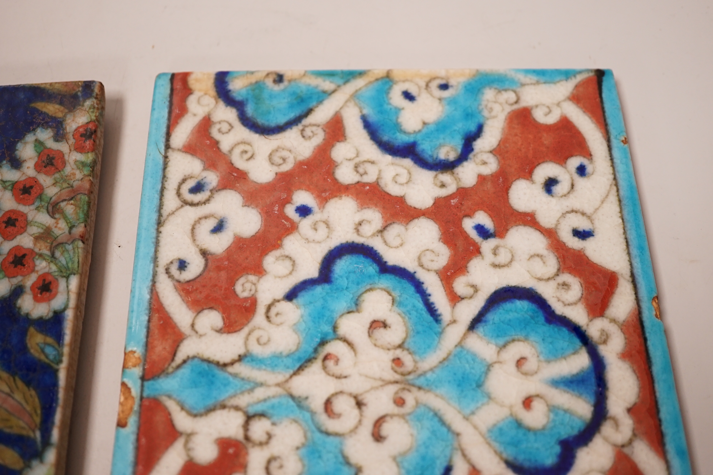 Two small Turkish Iznik pottery tiles, decorated with stylised flowers, each 24cm x 16cm